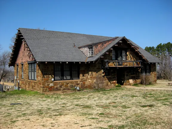 A stone and wood lodge on a sunny day.