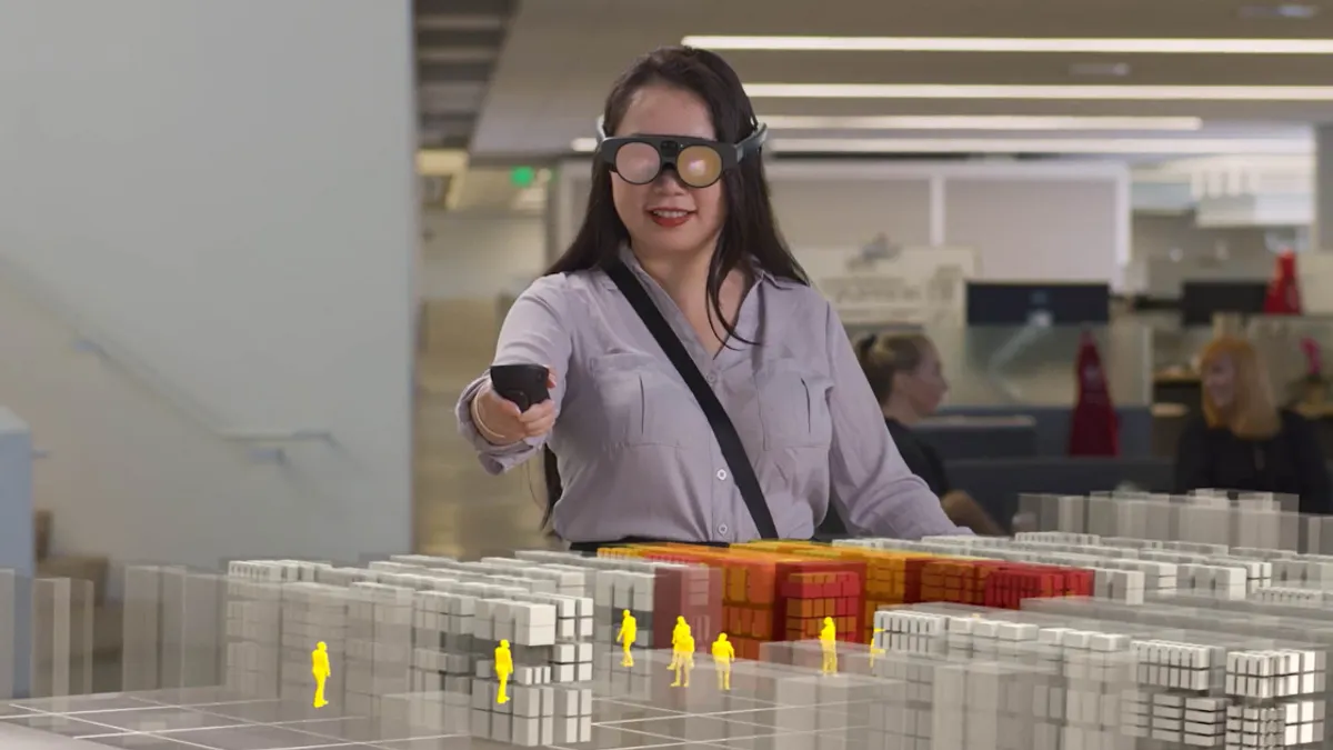 A store planner wears a Magic Leap 2 AR headset to visualize and make adjustments to a 3D store plan.