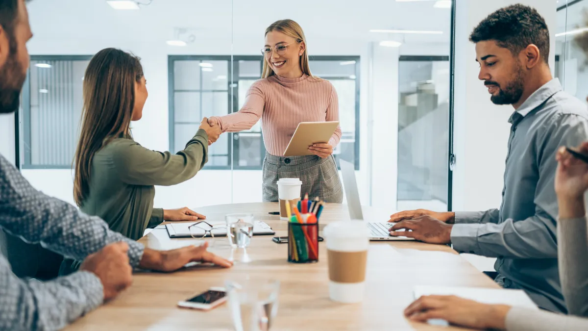 Shot of a group of businesspeople interviewing a candidate in an office.