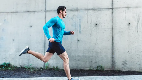 Person running in long sleeve blue shirt and black shorts