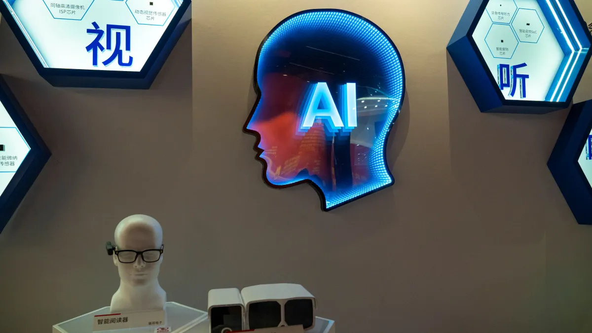 A display of artificial intelligence applications, including wearables, placed below an electronic sign of a human face's silhouette on which the phrase "AI" is superimposed.