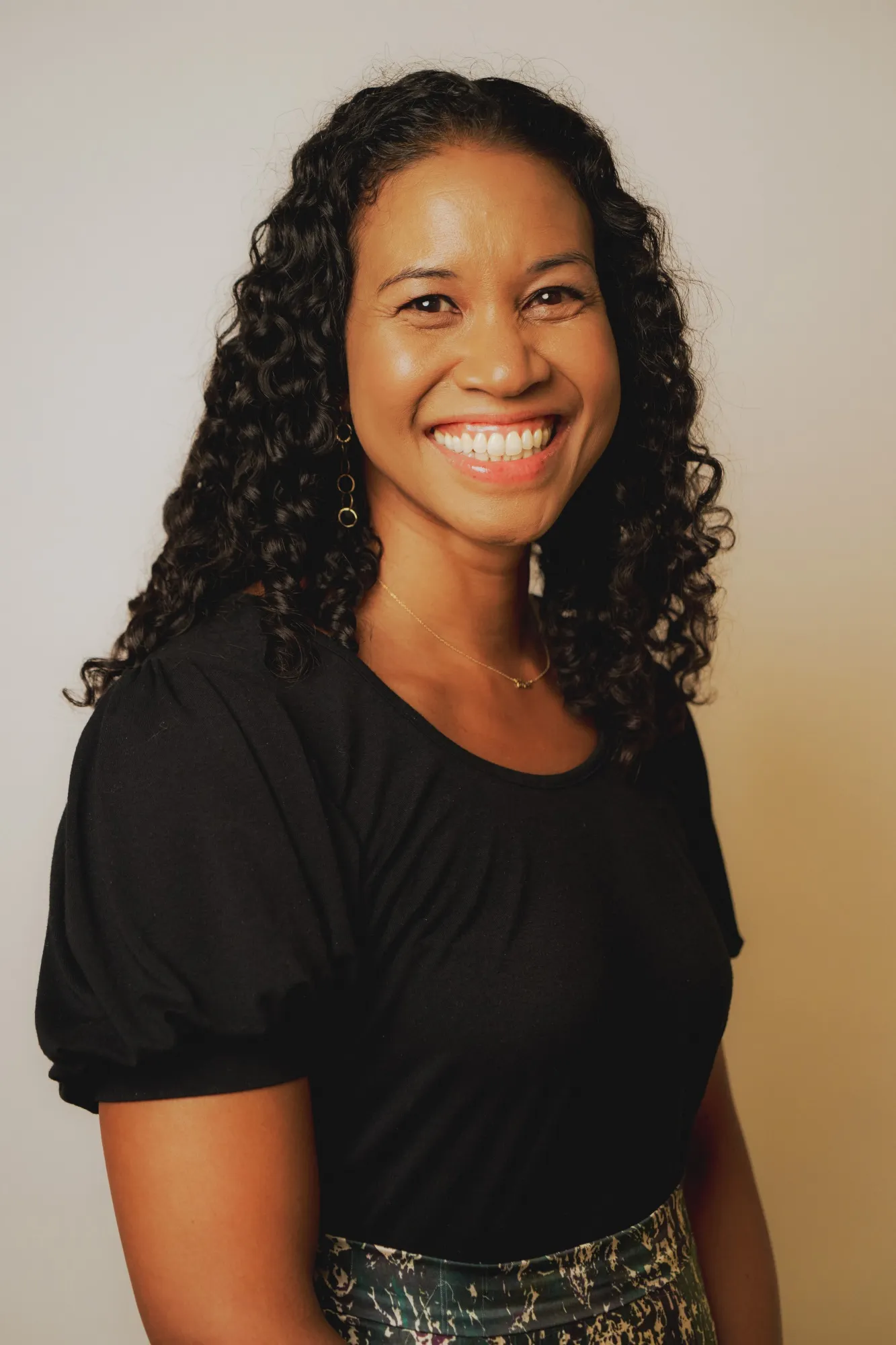A smiling woman in a black shirt