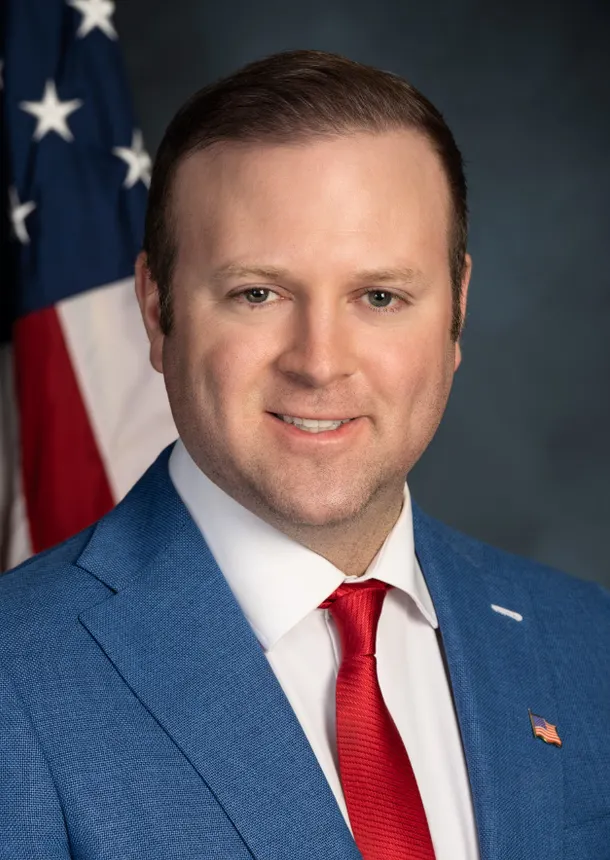 Headshot of a man in a suit.