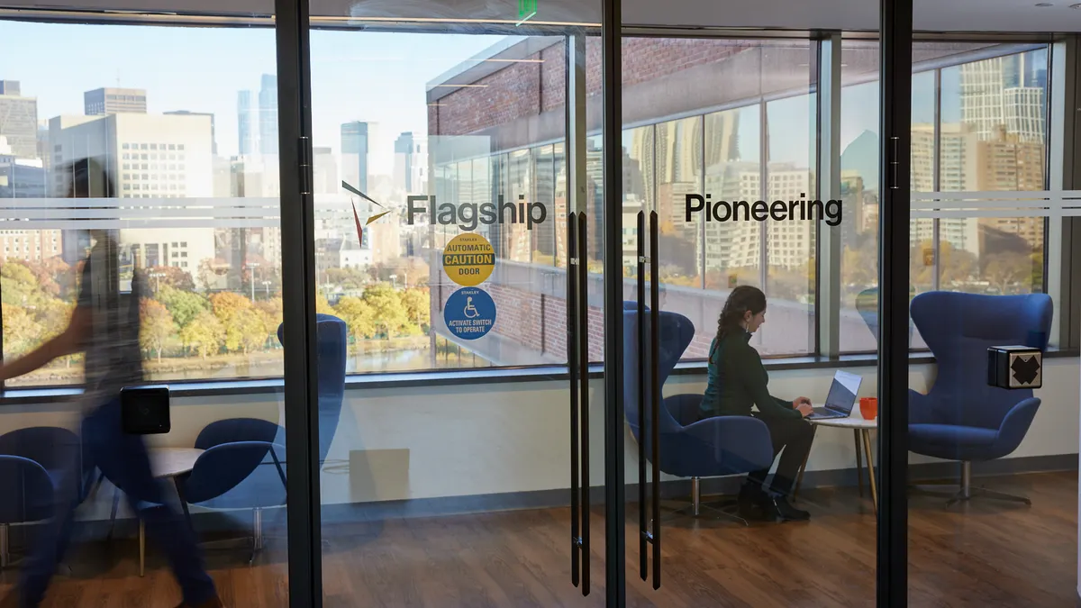 A photo of a window with the words "Flagship Pioneering" inside the company's office at 55 Cambridge Parkway in Boston.