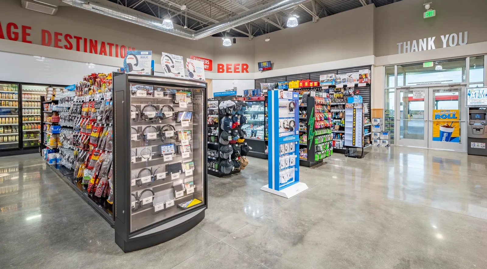 A photo of the inside of a store. Signs on the wall read &quot;thank you,&quot; &quot;destination&quot; and &quot;beer.&quot;