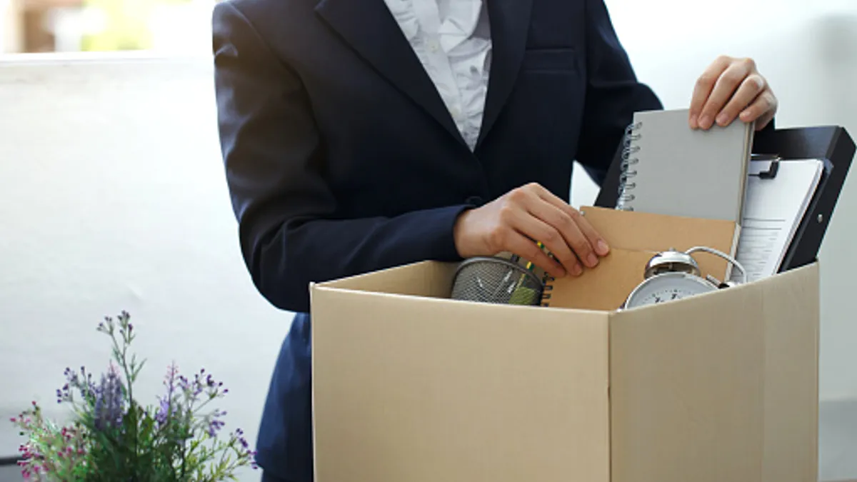 Person packing personal belongings before leaving the job