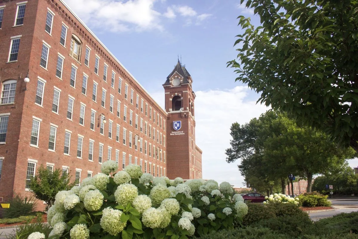 A large brick building with a bell tower on a clear spring day