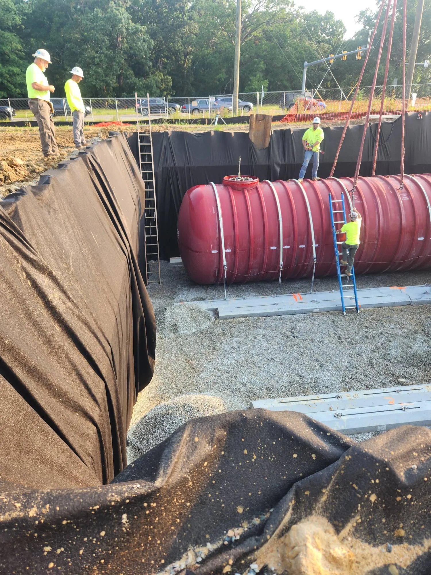 A photo of workers installing an underground storage tank.