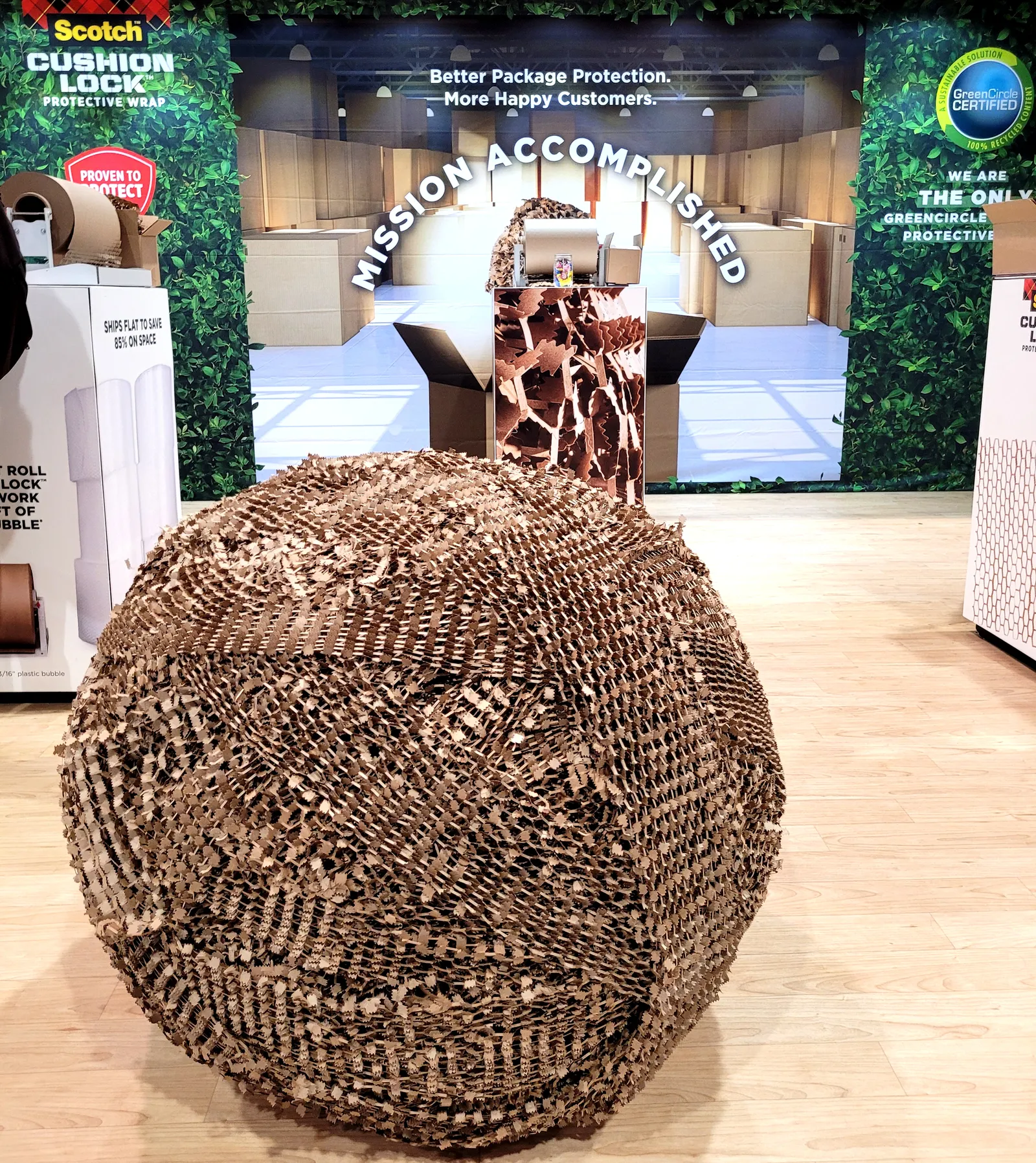 A large ball of rolled-up Scotch Cushion Lock at a convention booth.