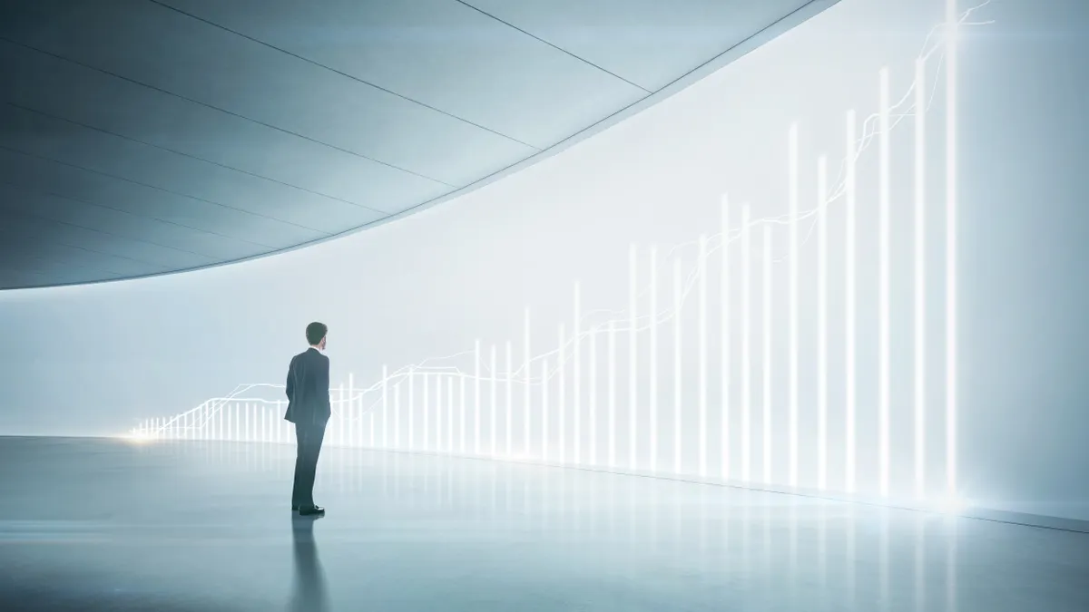 Business person looking at shining chart on the wall