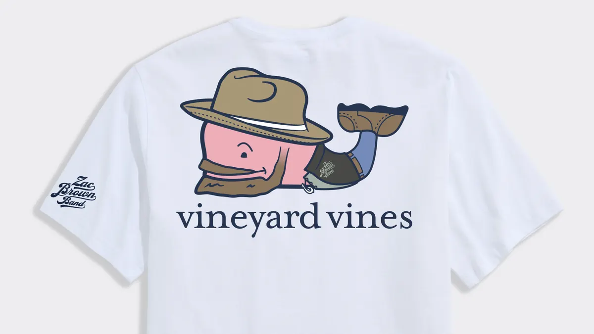 A white T-shirt features a Zac Brown Band logo in the shape of a whale.