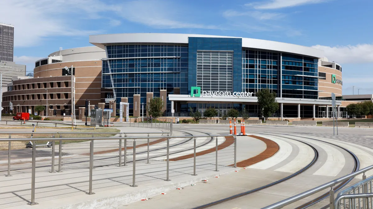 The exterior of an entertainment venue, and arena, is shown during the day.