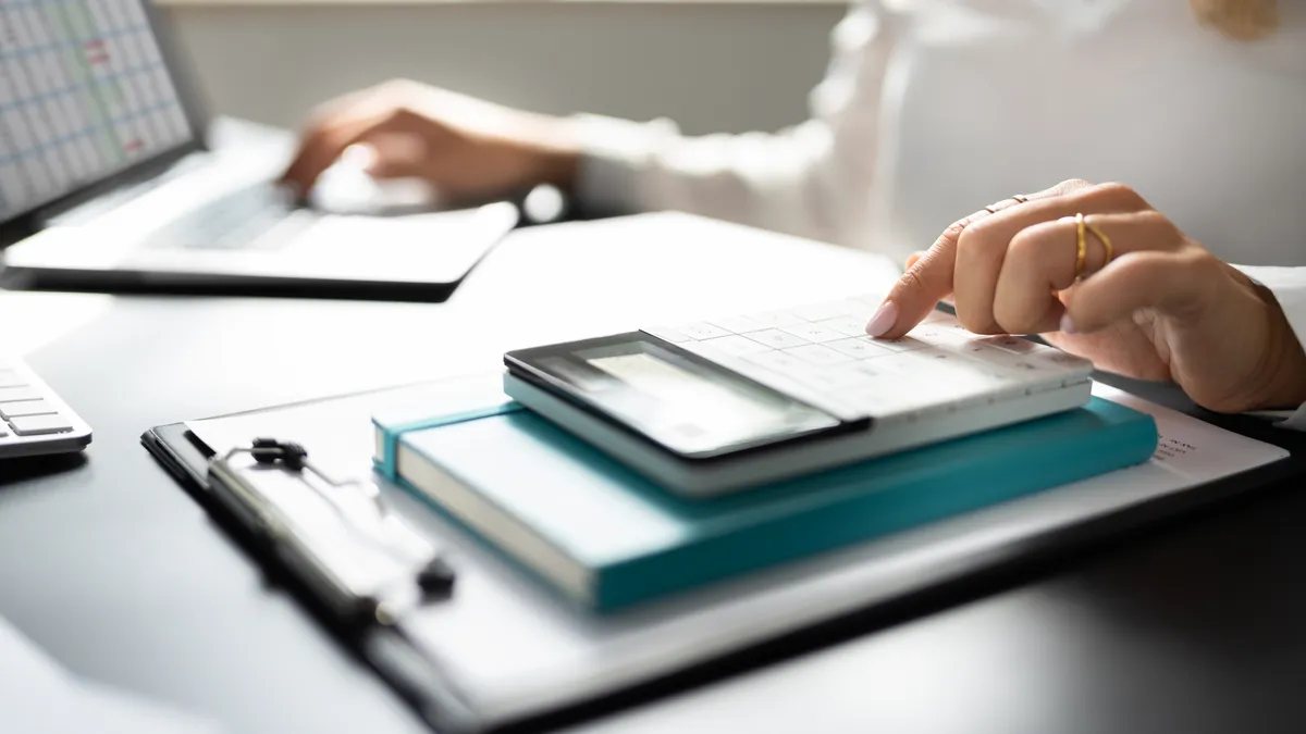 Accountant using calculator.