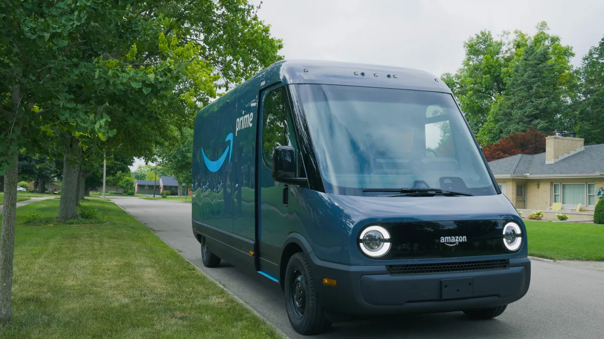 An Amazon delivery van made by Rivian sits in a neighborhood.