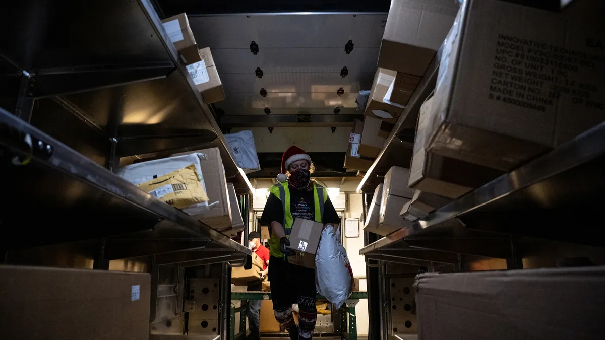 Amanda Eversole loads a package car at the UPS Centennial Ground Hub on December 6, 2021 in Louisville, Kentucky.