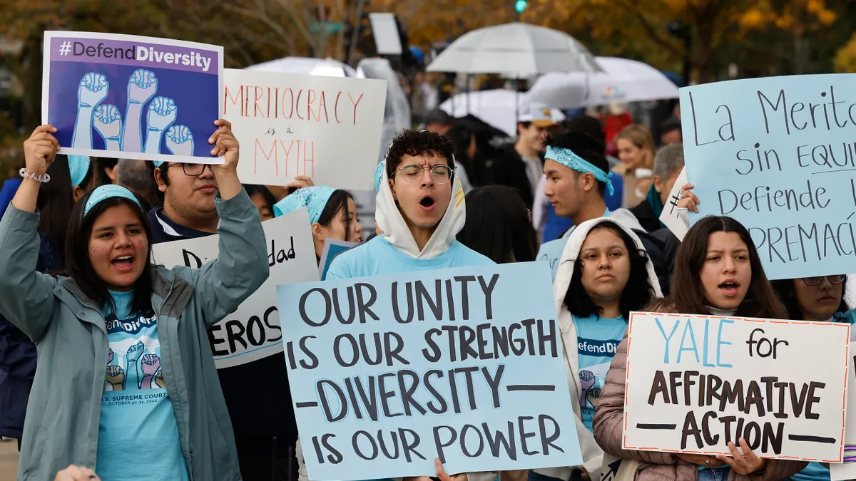 Protesters hold signs in favor of race-conscious admissions