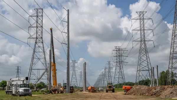 Heavy equipment is being used to install electric transmission lines.