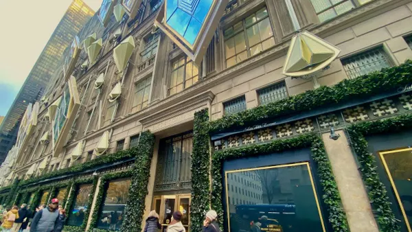 People walking past a department store.