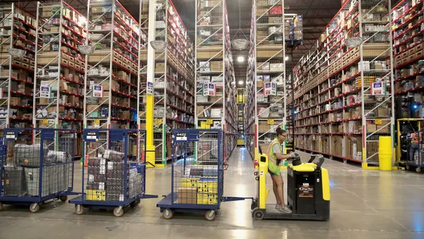 Workers pack and ship customer orders at the 750,000-square-foot Amazon fulfillment center on August 1, 2017 in Romeoville, Illinois.