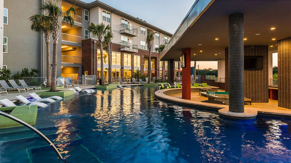 New apartment building surrounded by a pool