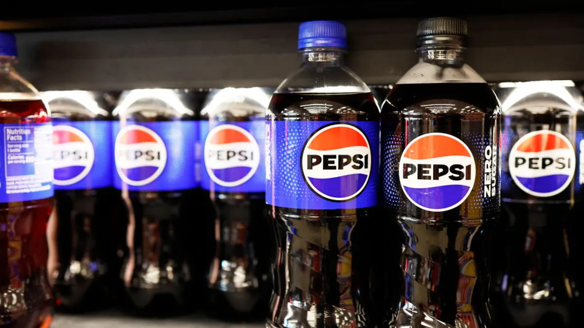Beverage bottles with Pepsi branding sit on a store shelf.