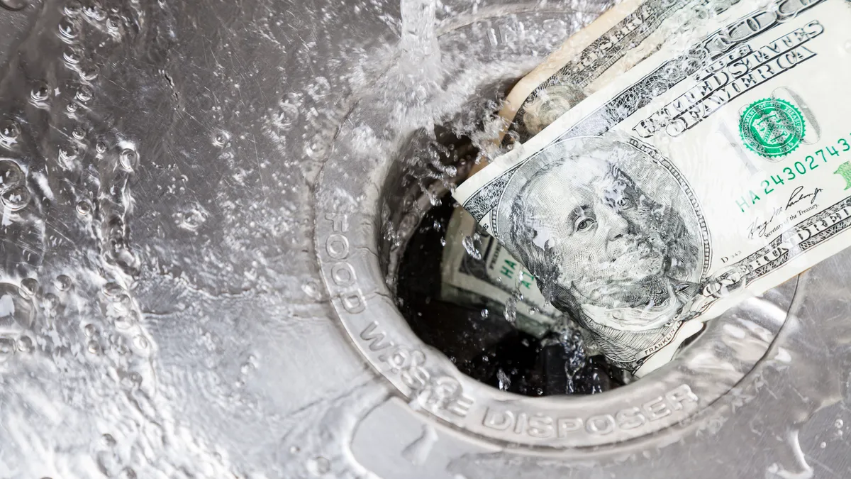 Money being washed down garbage disposal.