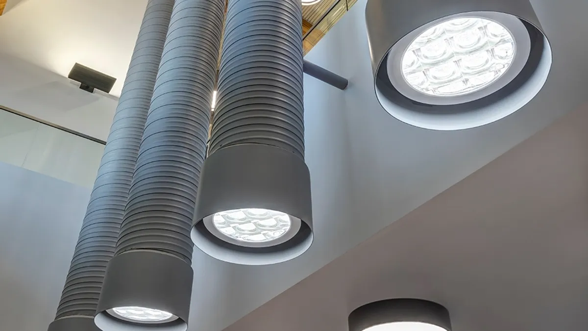 Three tube-shape lights in a commercial space.