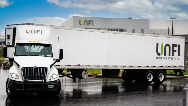 A freight truck with the UNFI logo.