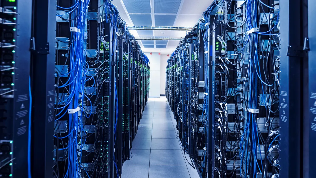A large number of servers in a server room or data center are connected by cables.