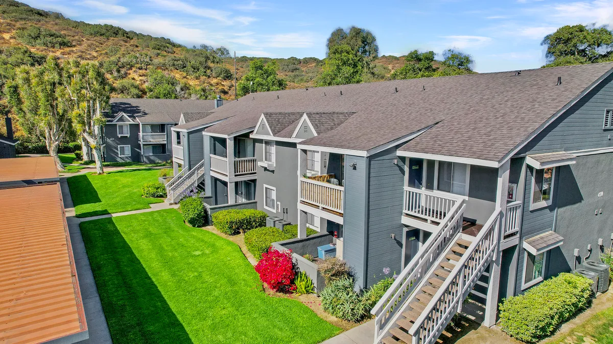 Gray two-level apartment homes with steps.