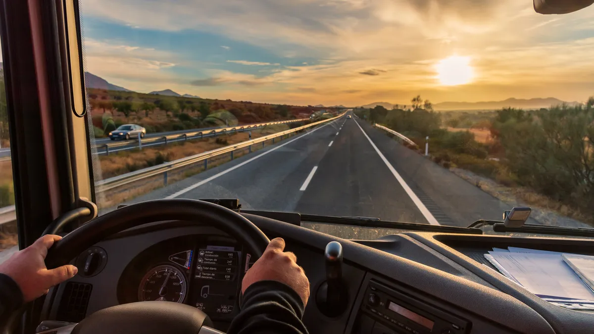 View from the driver's seat of a truck of the highway.