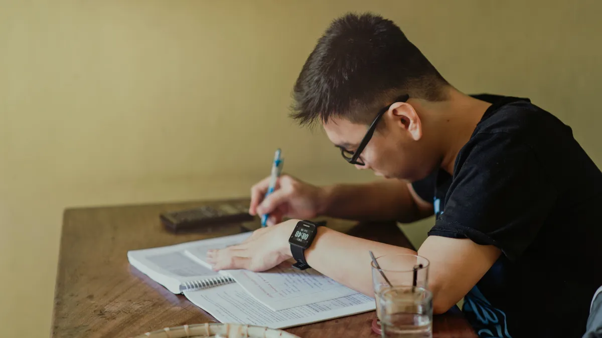 college student sits and a table studying