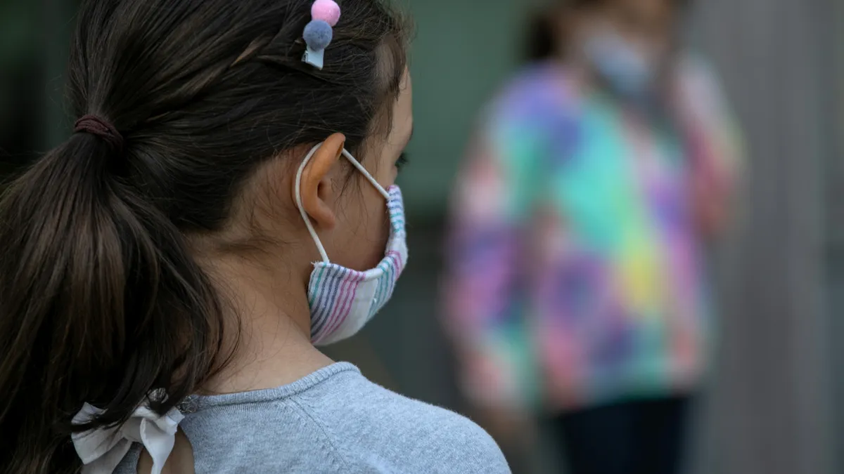 Masked school children wait to have their portraits taken during picture day at Rogers International School on September 23, 2020 in Stamford, Connecticut.