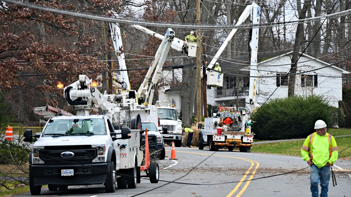 Utility crews repair downed power lines.
