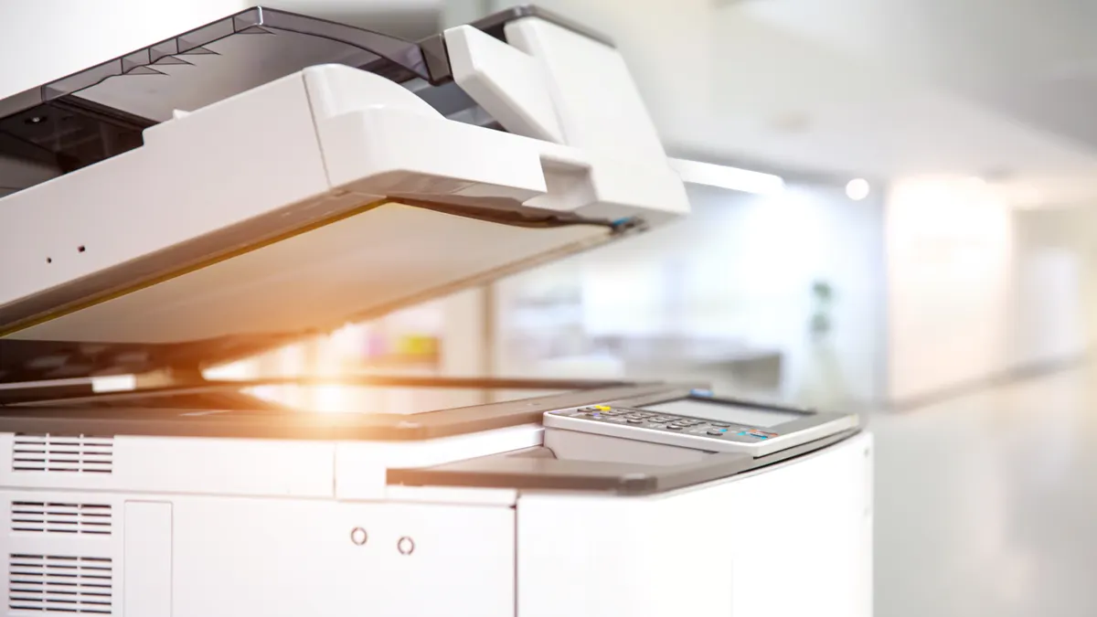 Close up picture of a photocopy and print machine in a workplace.