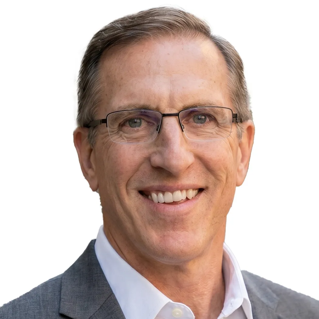 A person wearing glasses smiles for the camera