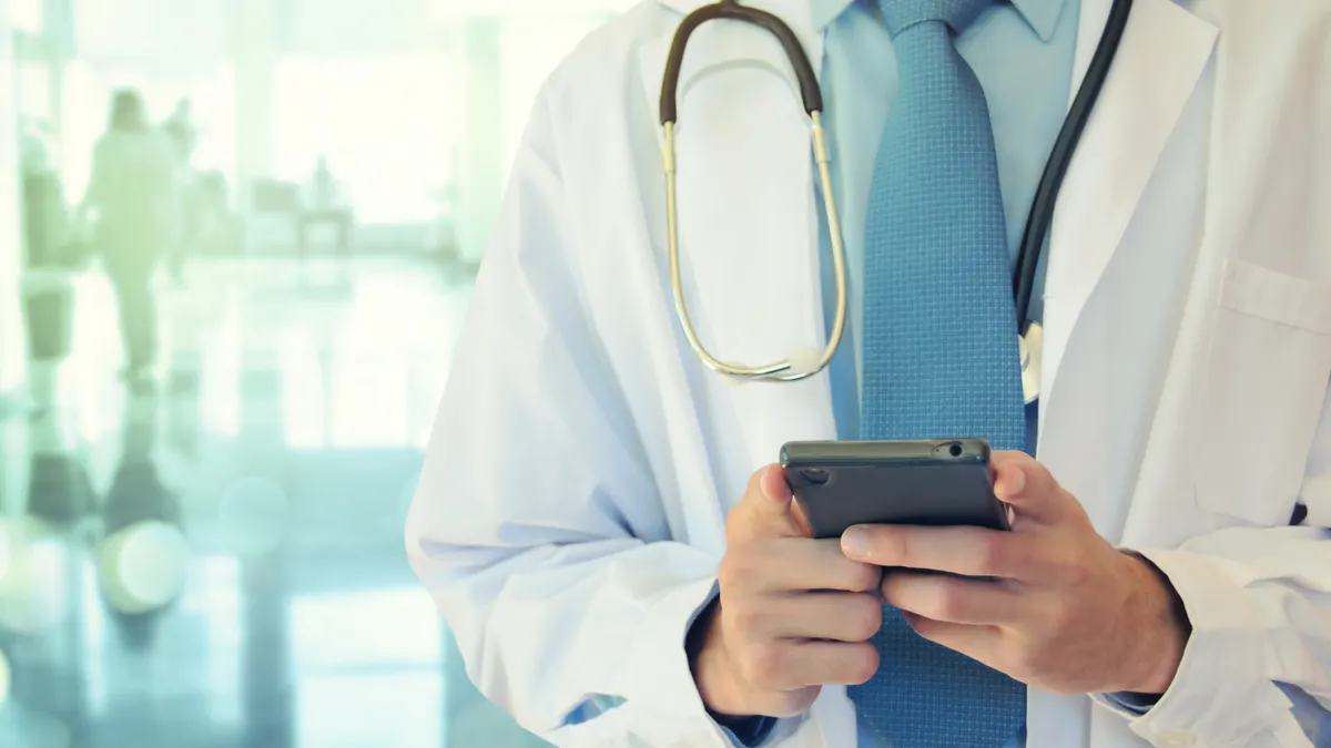 Doctor hands texting on a smart phone