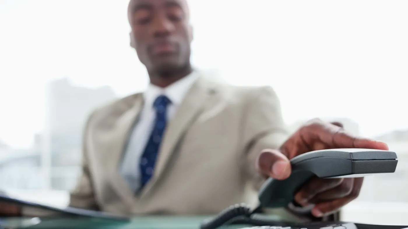 Man putting the office phone down