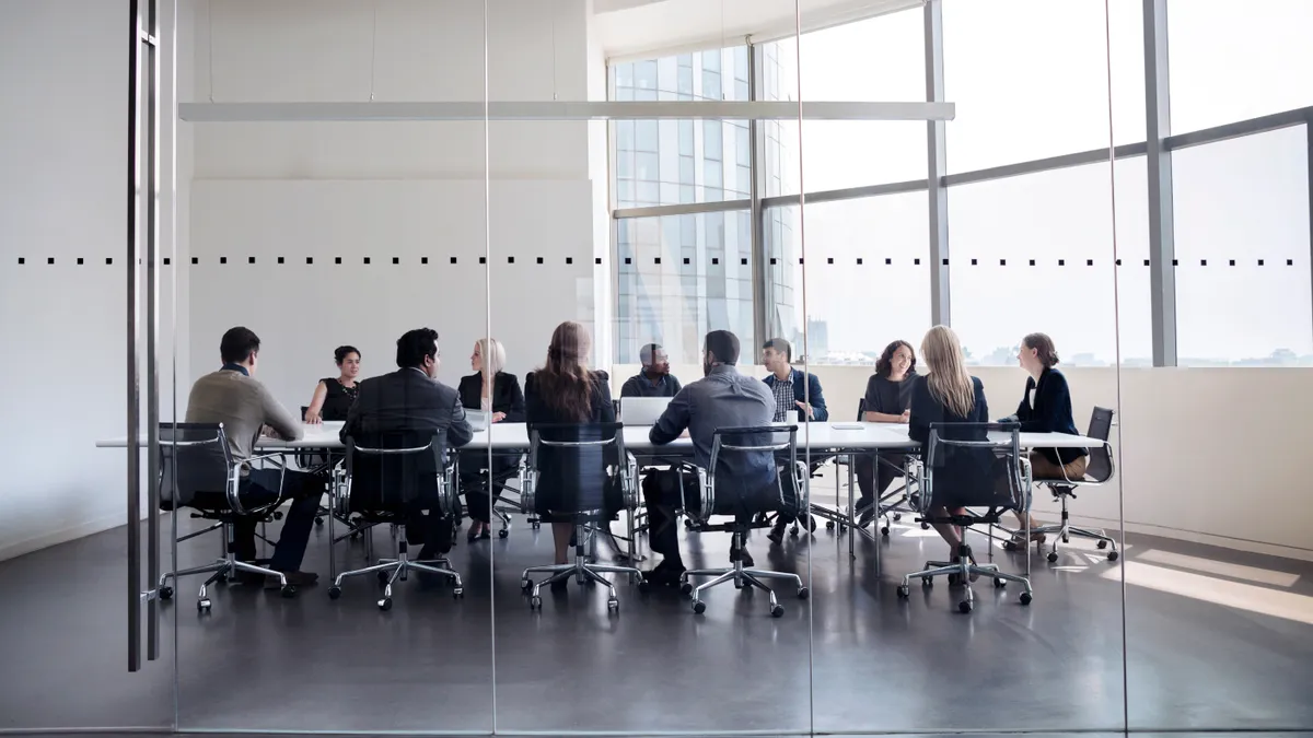 Colleagues at business meeting in conference room.