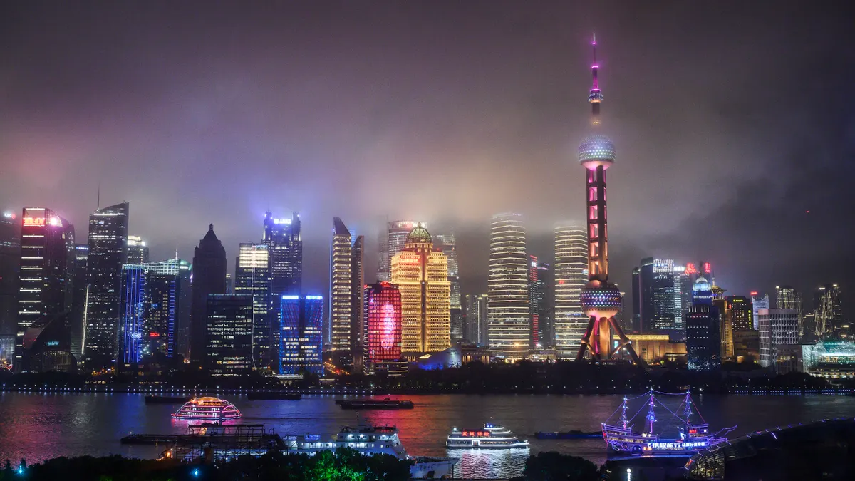 A nighttime view of the skyline of Shanghai, China across the Huangpu River.