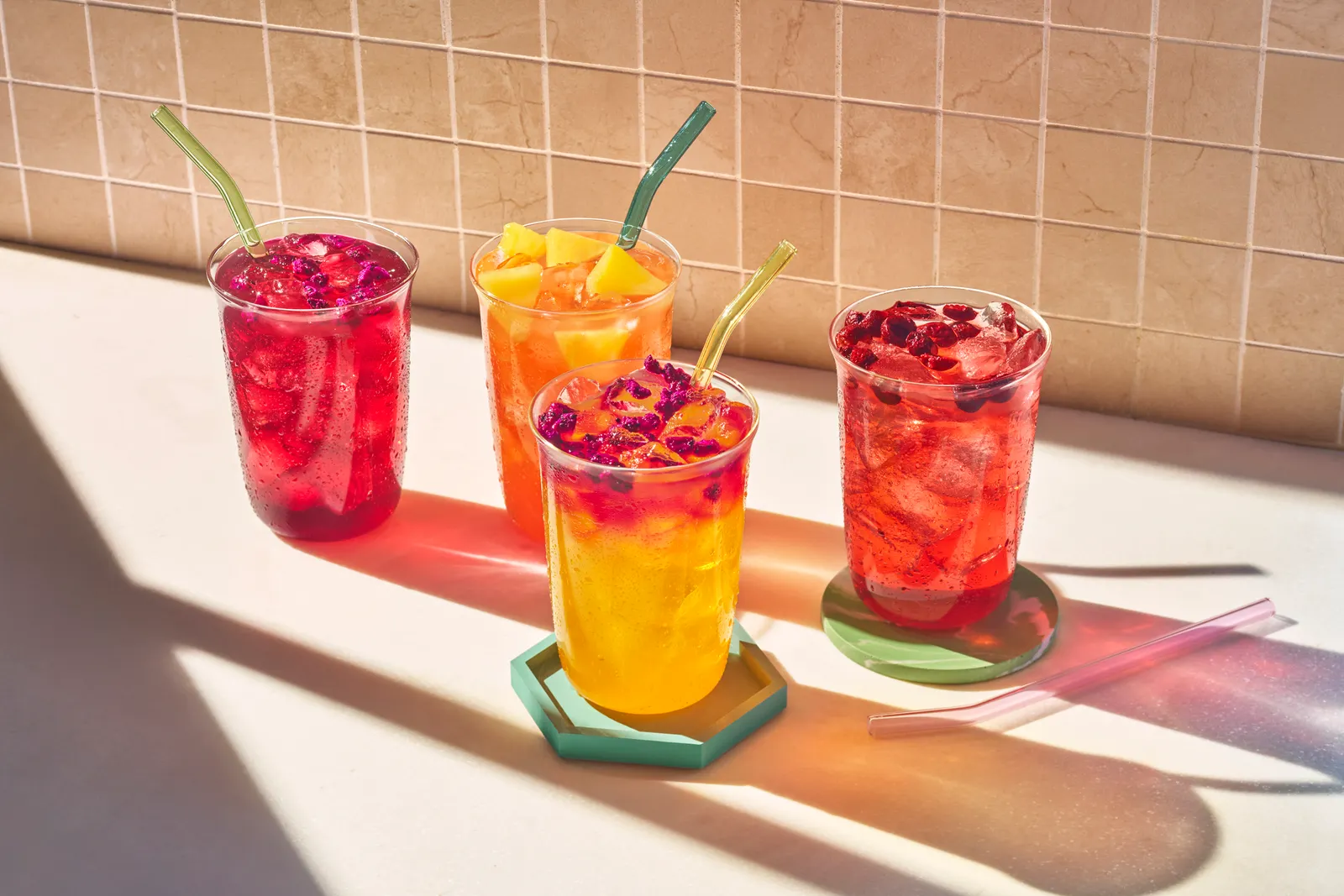 Four colorful drinks on a table.