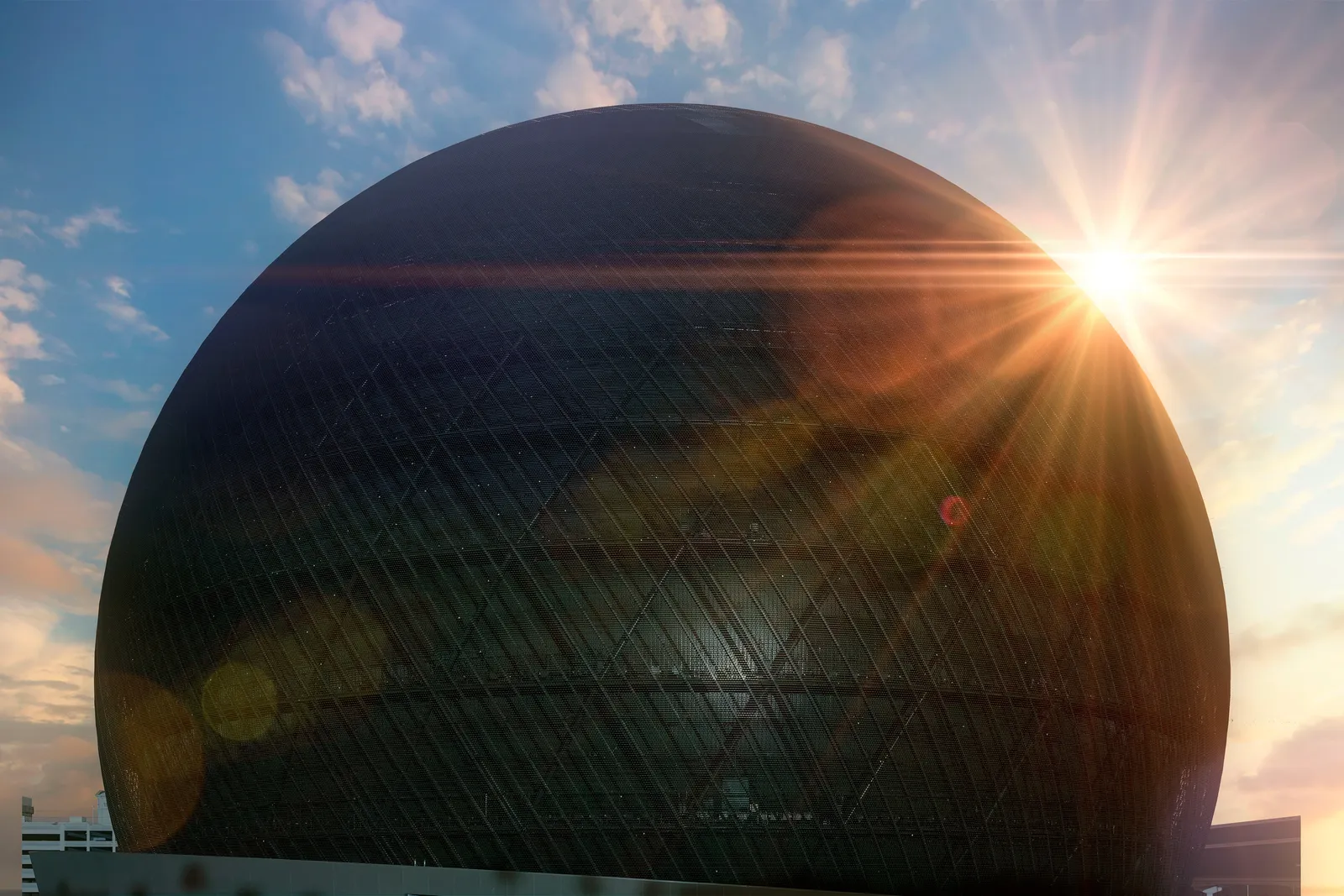 view of the MSG Sphere exterior with the sun behind the structure