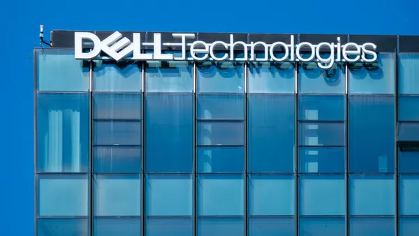 A glass office building facade with the Dell corporate logo is pictures.