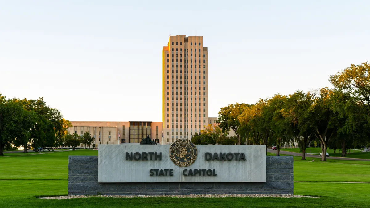 Facade of North Dakota State Capitol building with a sign that reads "North Dakota State Capitol"