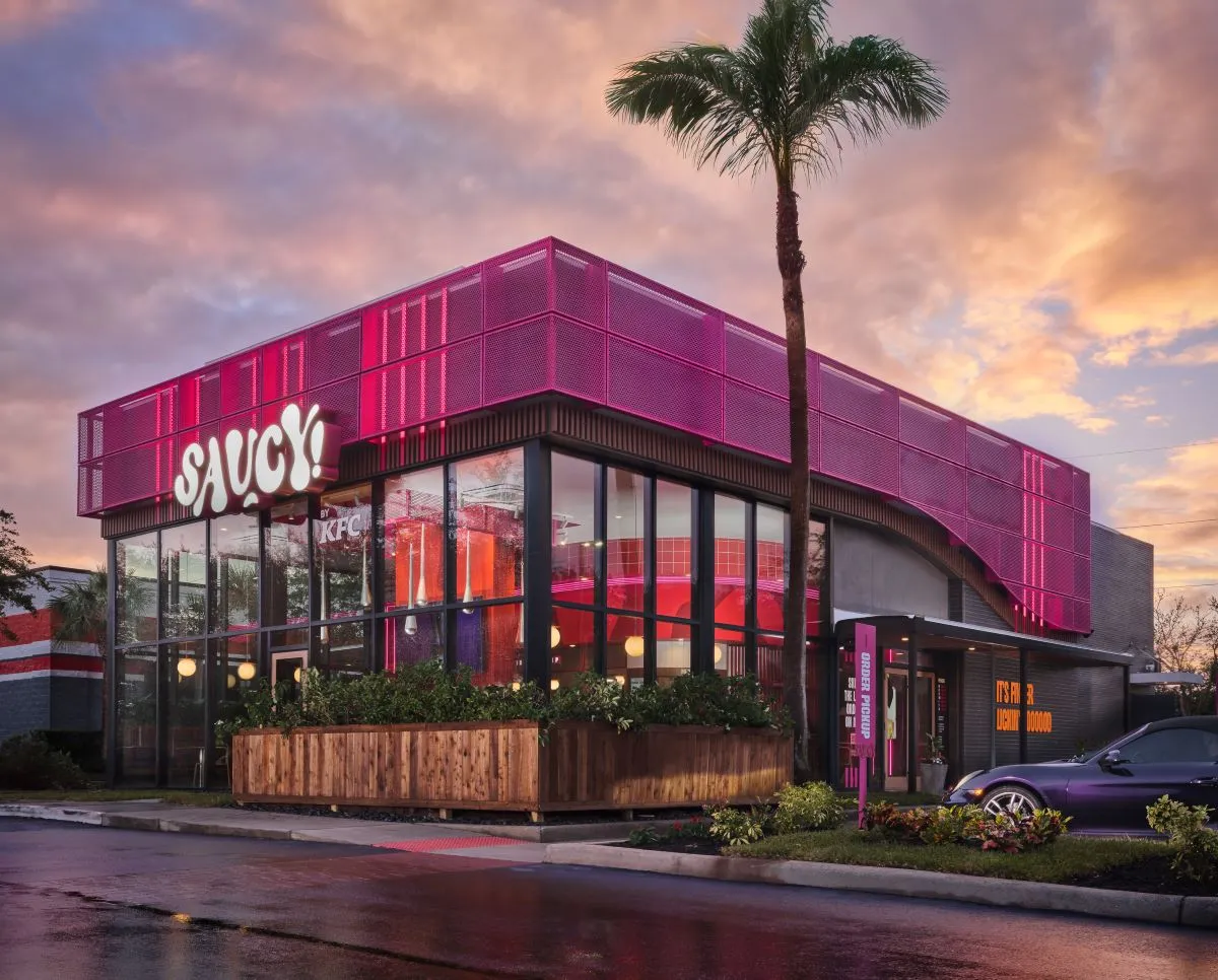 An exterior pink building with Saucy by KFC signage