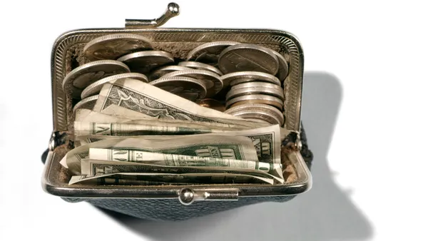 A black pocketbook with cash and coins.