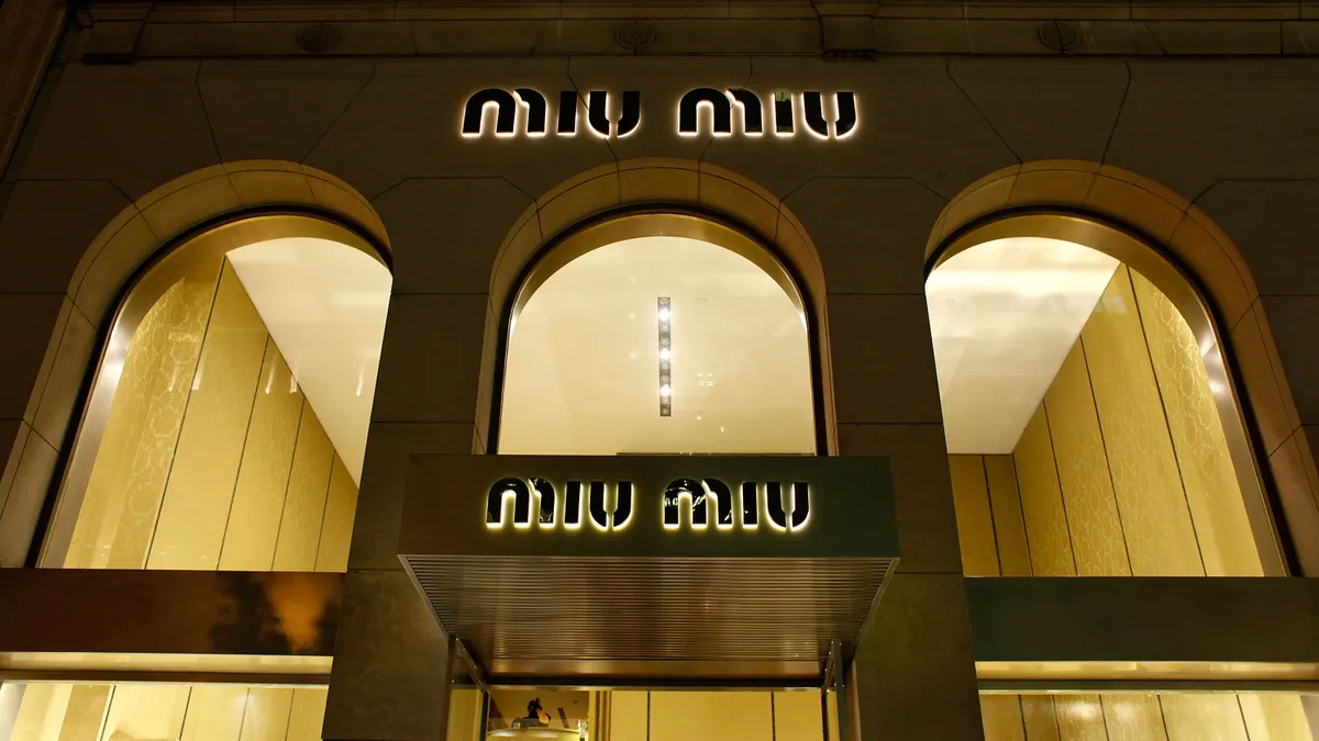 Outside view of a Miu Miu store at night.