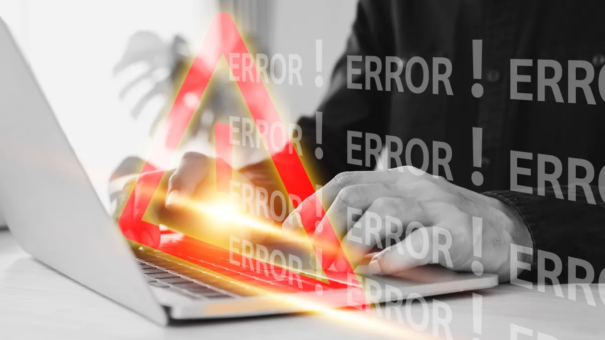 Person at a laptop with an exclamation point and error messaging