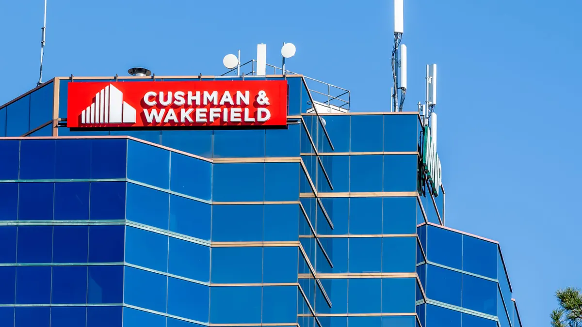 A sign for Cushman & Wakefield on an office tower.
