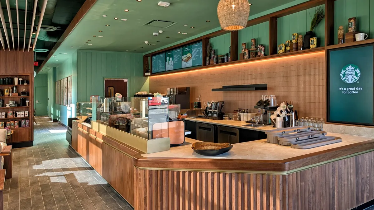 An empty Starbucks redesigned with lots of green and open space.